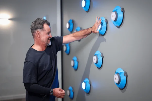 Person interacting with a light-based reaction training system.
