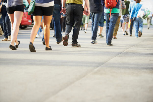Crowd of people walking in a public space, representing the millions of Australians living with neurological conditions.